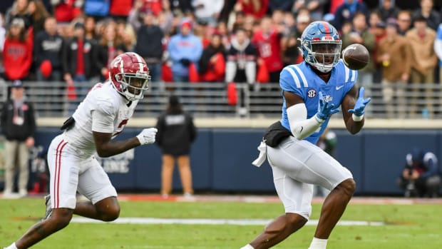 Nov 12, 2022; Oxford, Mississippi, USA; Ole Miss wide receiver Jonathan Mingo (1) catches a pass with Alabama defensive back DeMarcco Hellams (2) covering at Vaught-Hemingway Stadium. Mandatory Credit: Gary Cosby Jr.-USA TODAY Sports